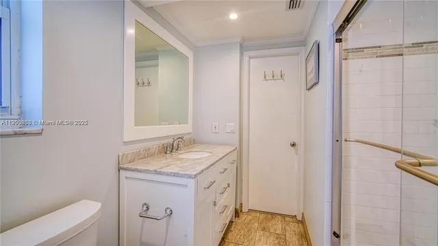 a spacious bathroom with a double vanity sink a toilet and a mirror
