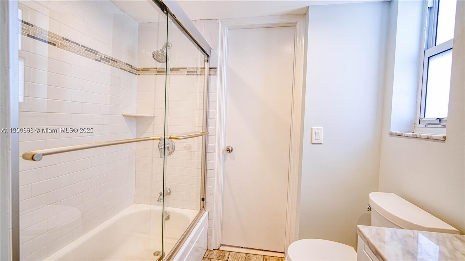 2900 Banyan Street, Unit 408 Fort Lauderdale, FL 33316 - Photo 22 of 29 a bathroom with a shower a toilet and a sink