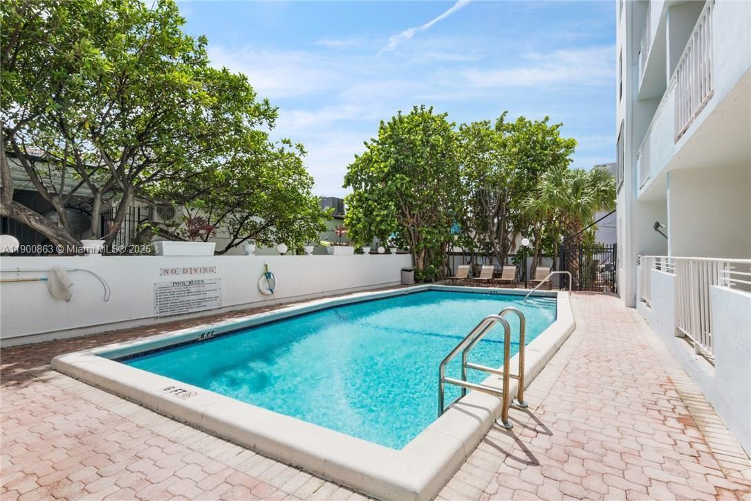 2900 Banyan Street, Unit 408 Fort Lauderdale, FL 33316 - Photo 28 of 29 a view of a swimming pool with a patio and a yard