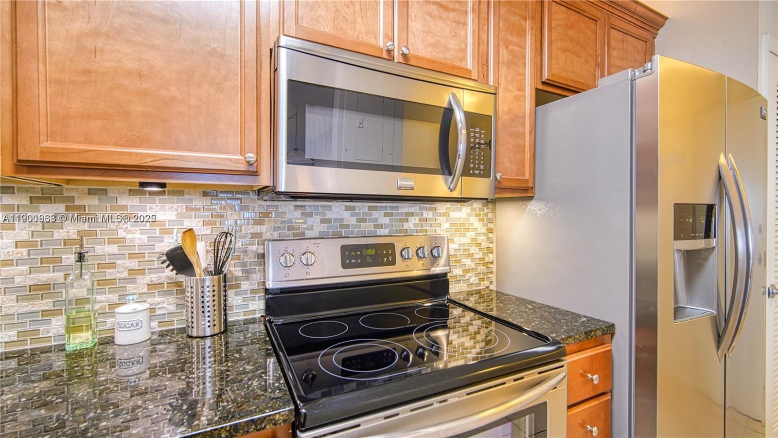2900 Banyan Street, Unit 408 Fort Lauderdale, FL 33316 - Photo 9 of 29 a kitchen with a stove and a microwave