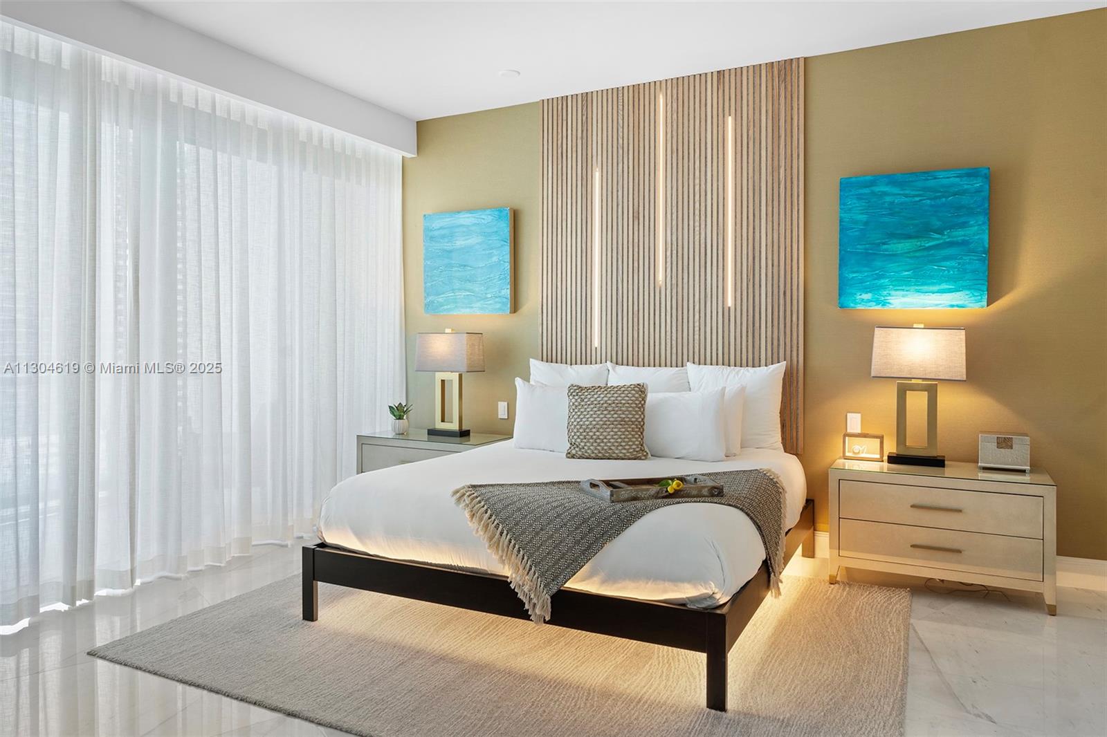 2201 Collins Avenue, Unit 1926/PH Miami Beach, FL 33139 - Photo 15 of 47 a bedroom with a bed a lamp and a large window