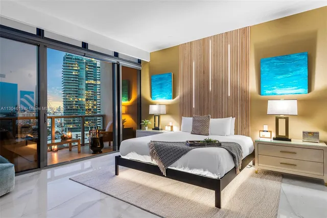 a living room with large windows and a table