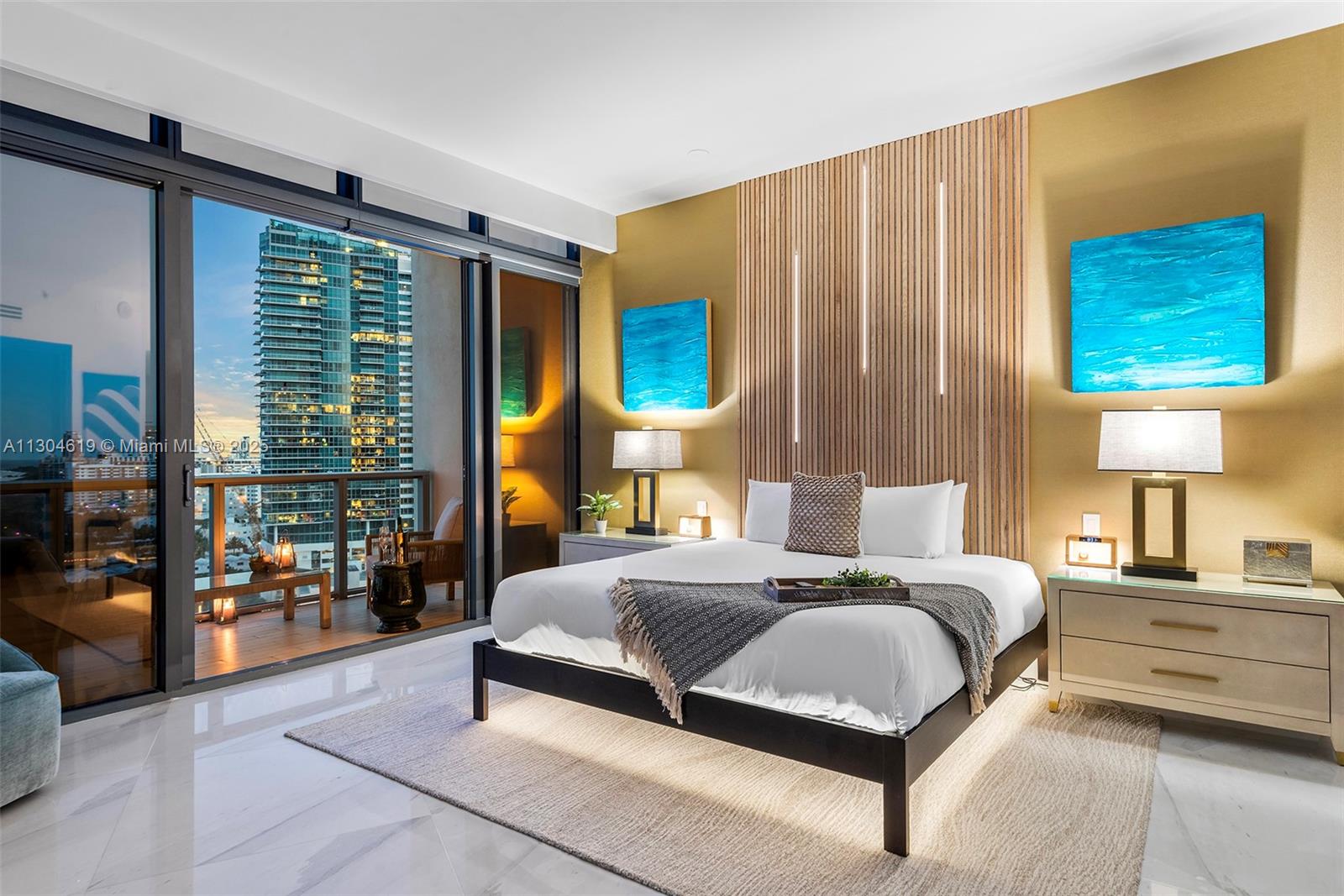 2201 Collins Avenue, Unit 1926/PH Miami Beach, FL 33139 - Photo 26 of 47 a bedroom with a bed lamp and window