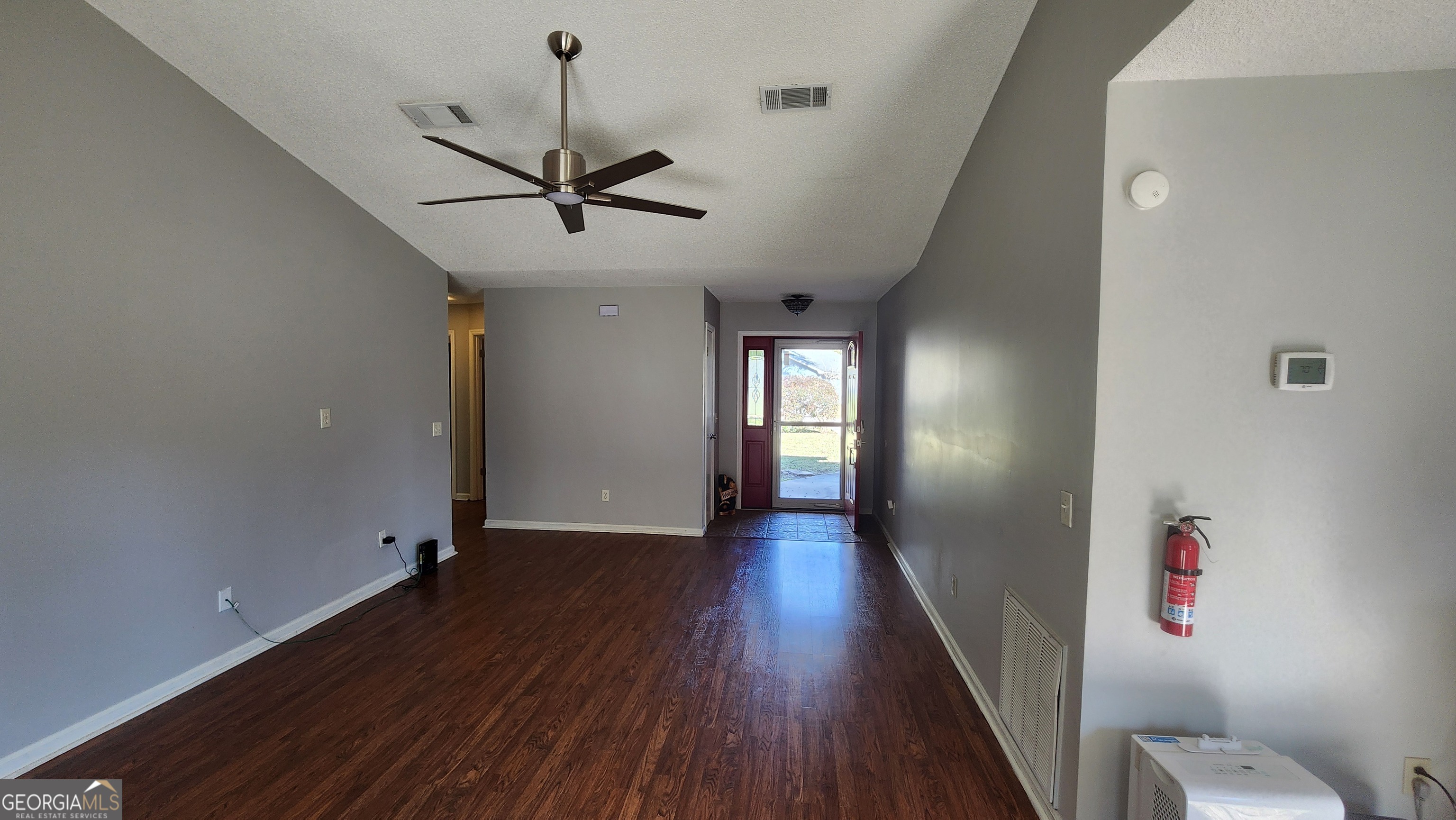 113 Almond Circle Kingsland, GA 31548 - Photo 11 of 34 a view of a hallway with wooden floor and cabinet