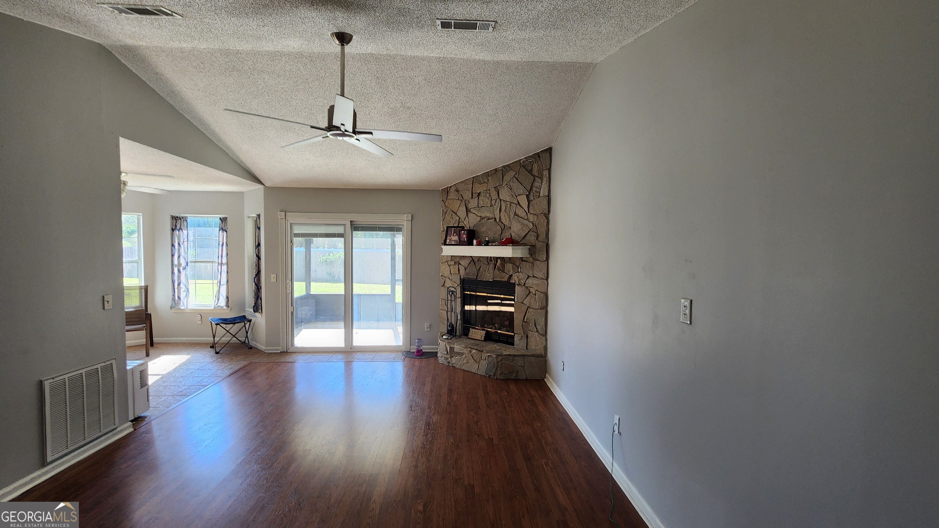 113 Almond Circle Kingsland, GA 31548 - Photo 15 of 34 a view of a hallway with wooden floor and a ceiling fan
