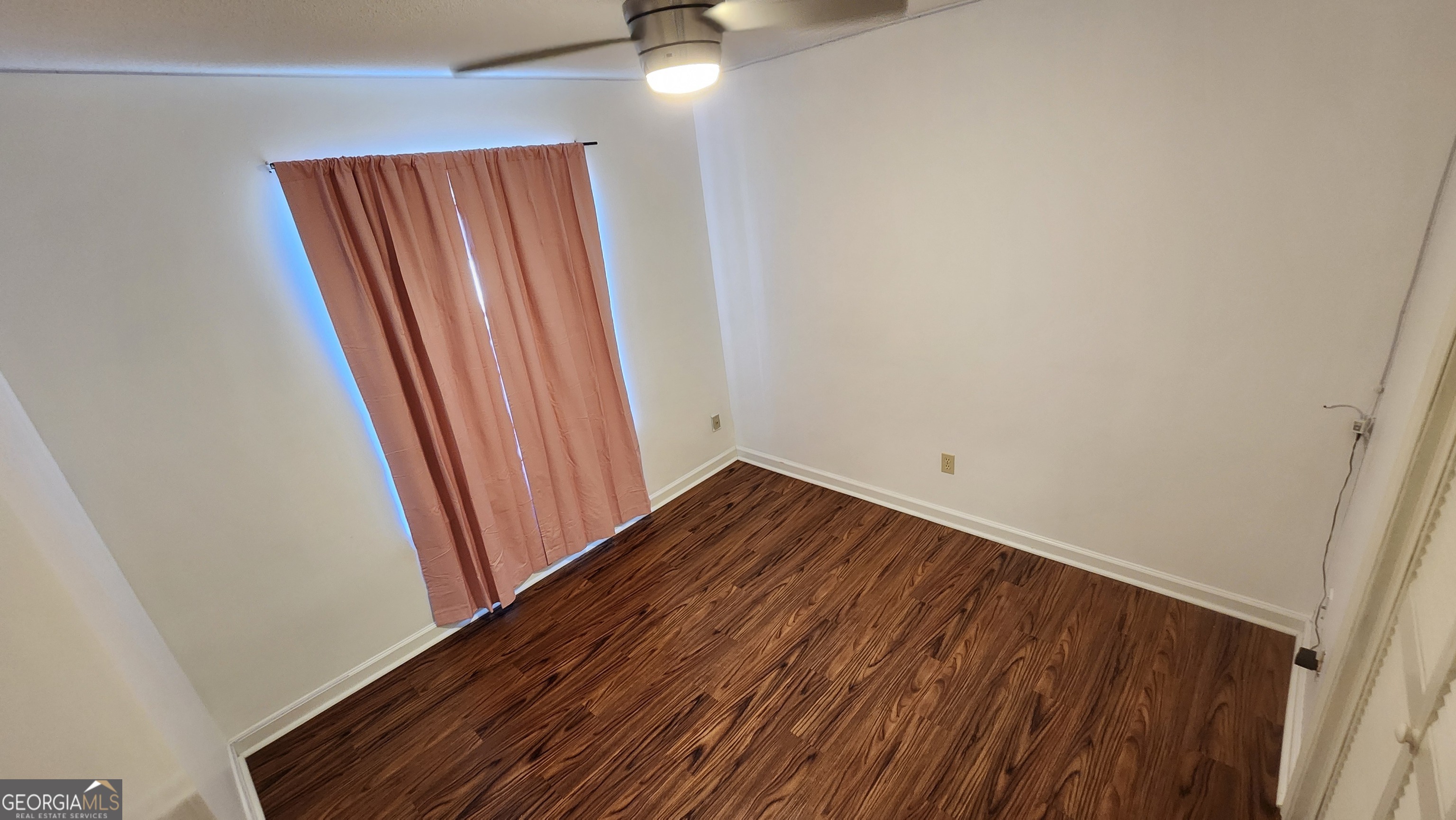 113 Almond Circle Kingsland, GA 31548 - Photo 23 of 34 an empty room with wooden floor and windows