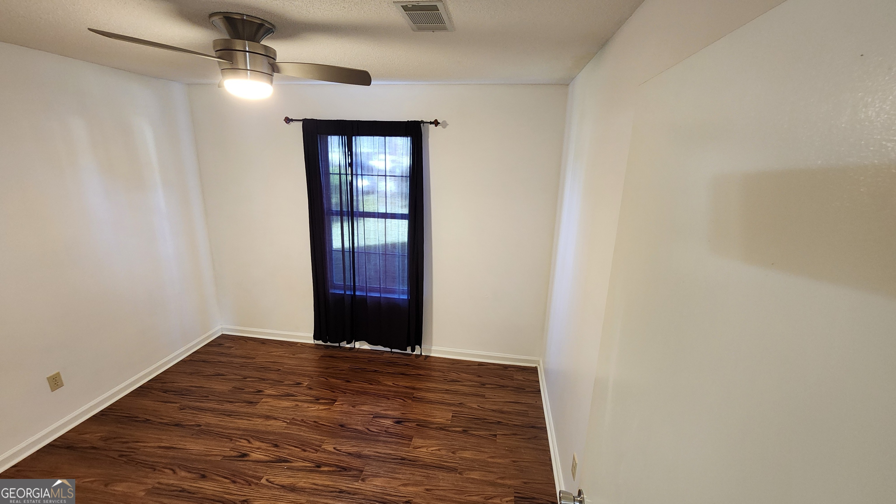 113 Almond Circle Kingsland, GA 31548 - Photo 26 of 34 wooden floor in an empty room with a window