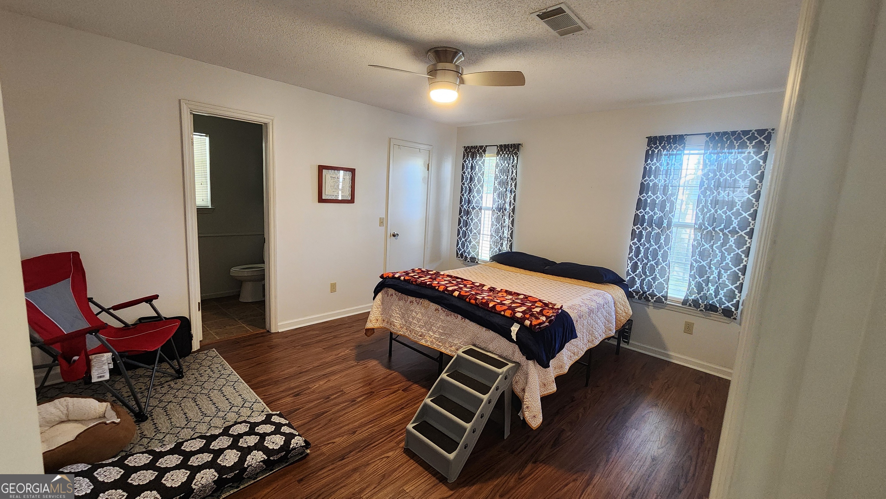 113 Almond Circle Kingsland, GA 31548 - Photo 29 of 34 a bedroom with a bed and wooden floor