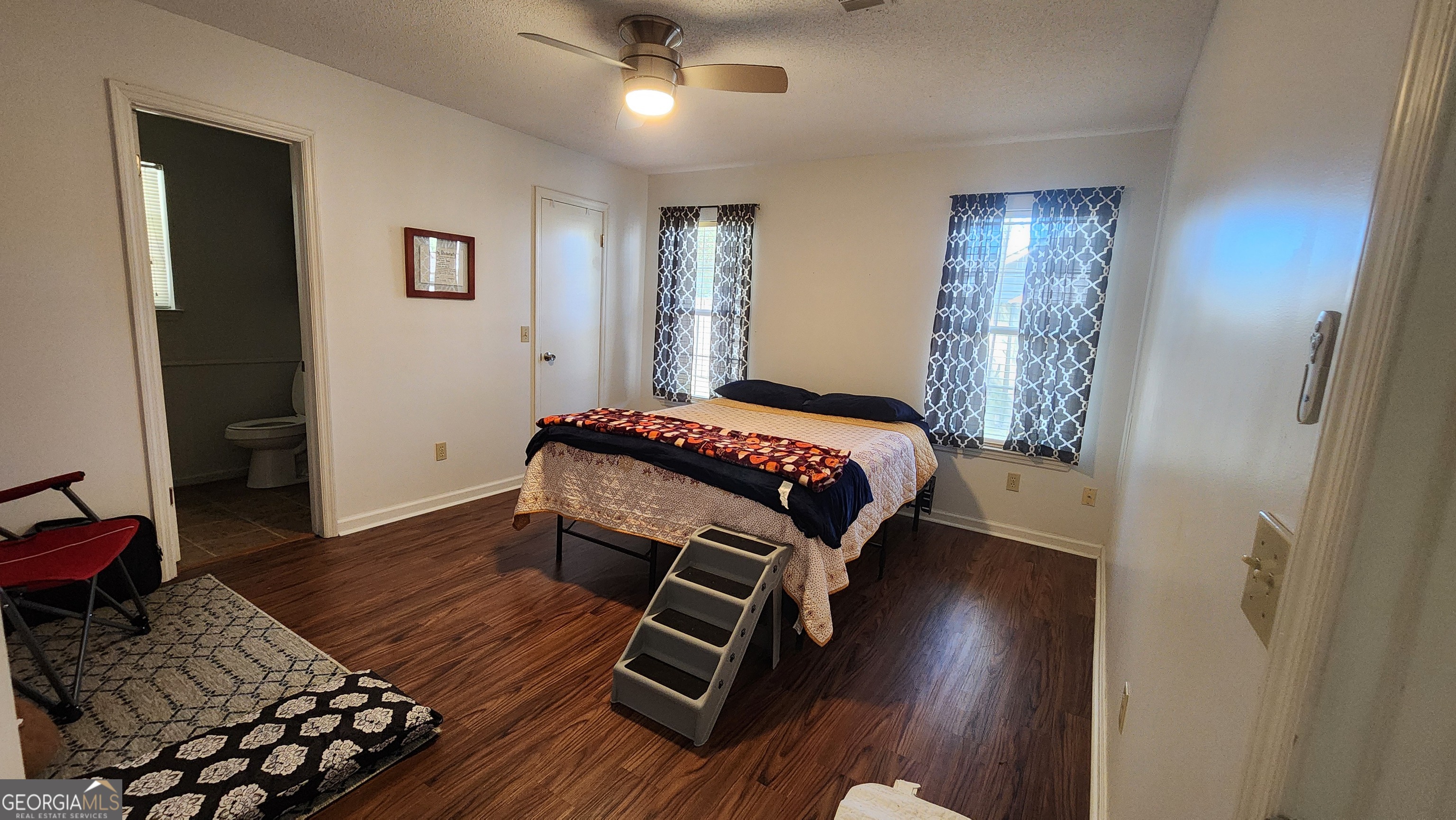 113 Almond Circle Kingsland, GA 31548 - Photo 30 of 34 a bedroom with a bed and wooden floor