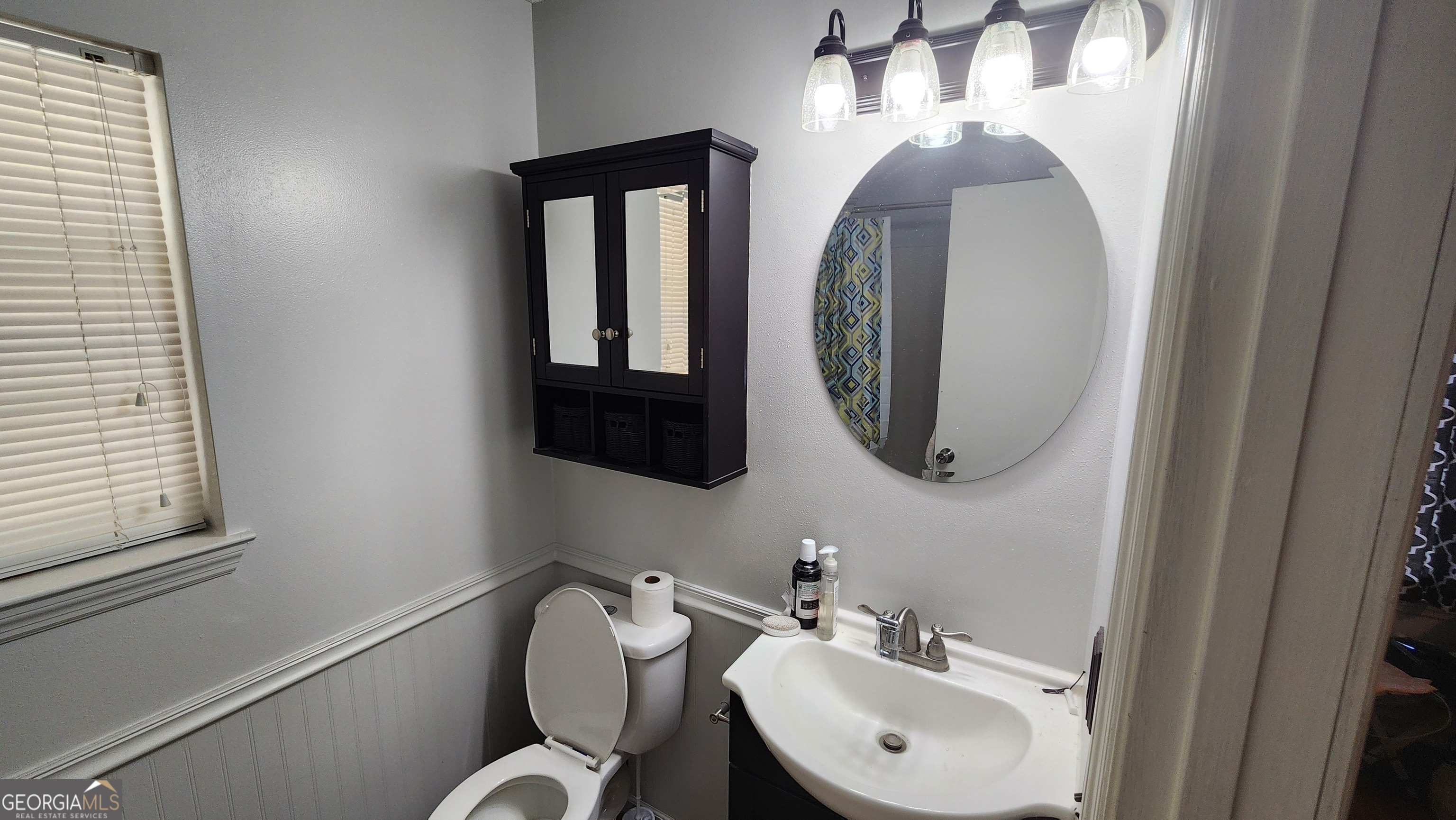 113 Almond Circle Kingsland, GA 31548 - Photo 31 of 34 a bathroom with a toilet sink and mirror