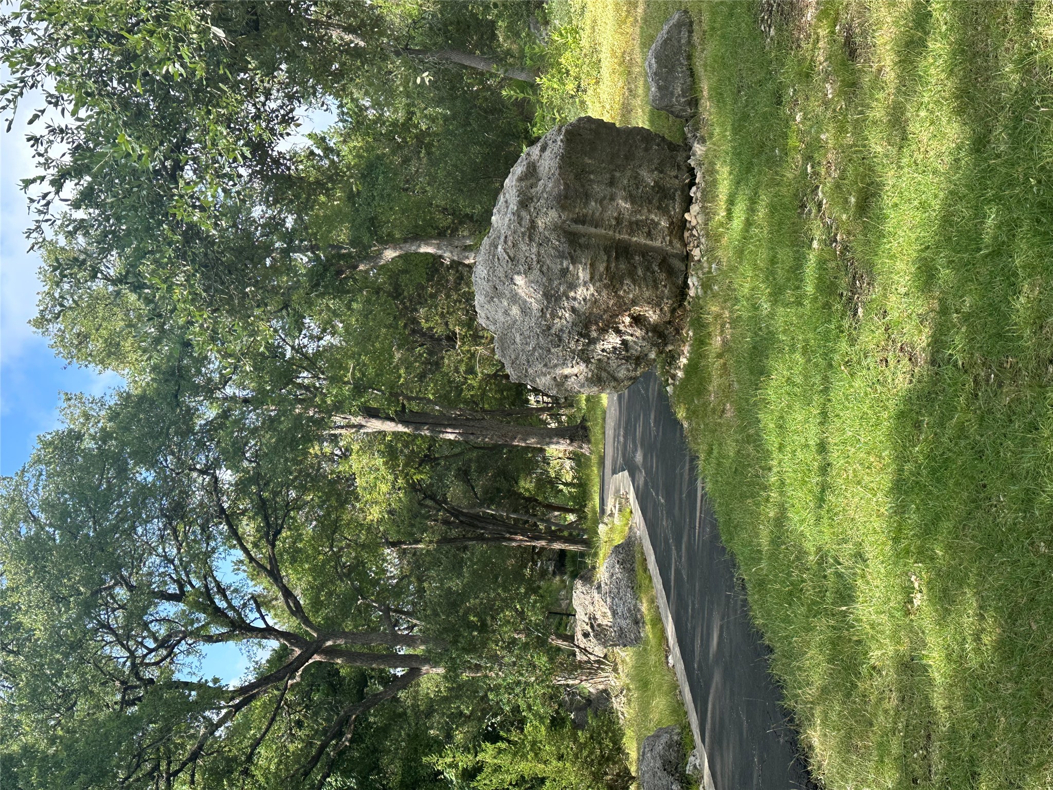 0 Lantana Gold Spring Branch, TX 78070 - Photo 20 of 26 A winding path through verdant trees and natural rock formations, perfect for tranquil strolls.