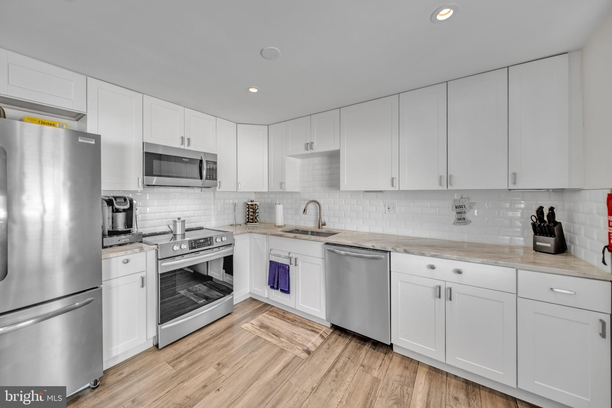 6206 Clinton Way Clinton, MD 20735 - Photo 9 of 31 Modern kitchen with sleek white cabinetry.