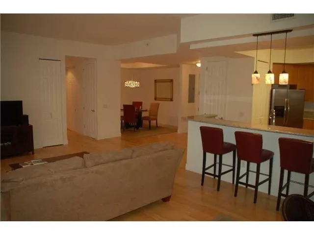 a view of a balcony with wooden floor and outdoor seating