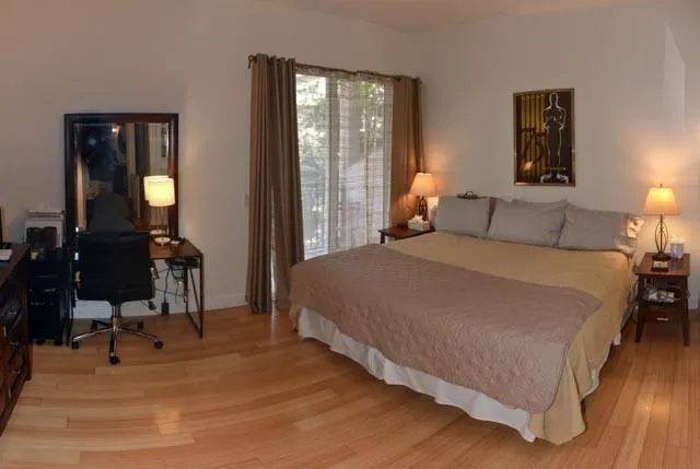 a bed sitting in a bedroom next to a lamp