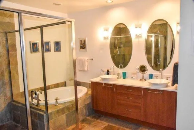 a bathroom with a sink a toilet and shower
