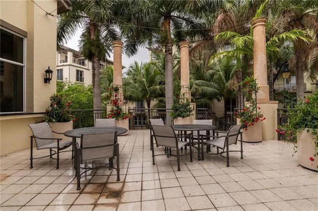 a front view of a house with a yard and fountain