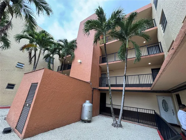 a view of balcony with potted plants and palm trees