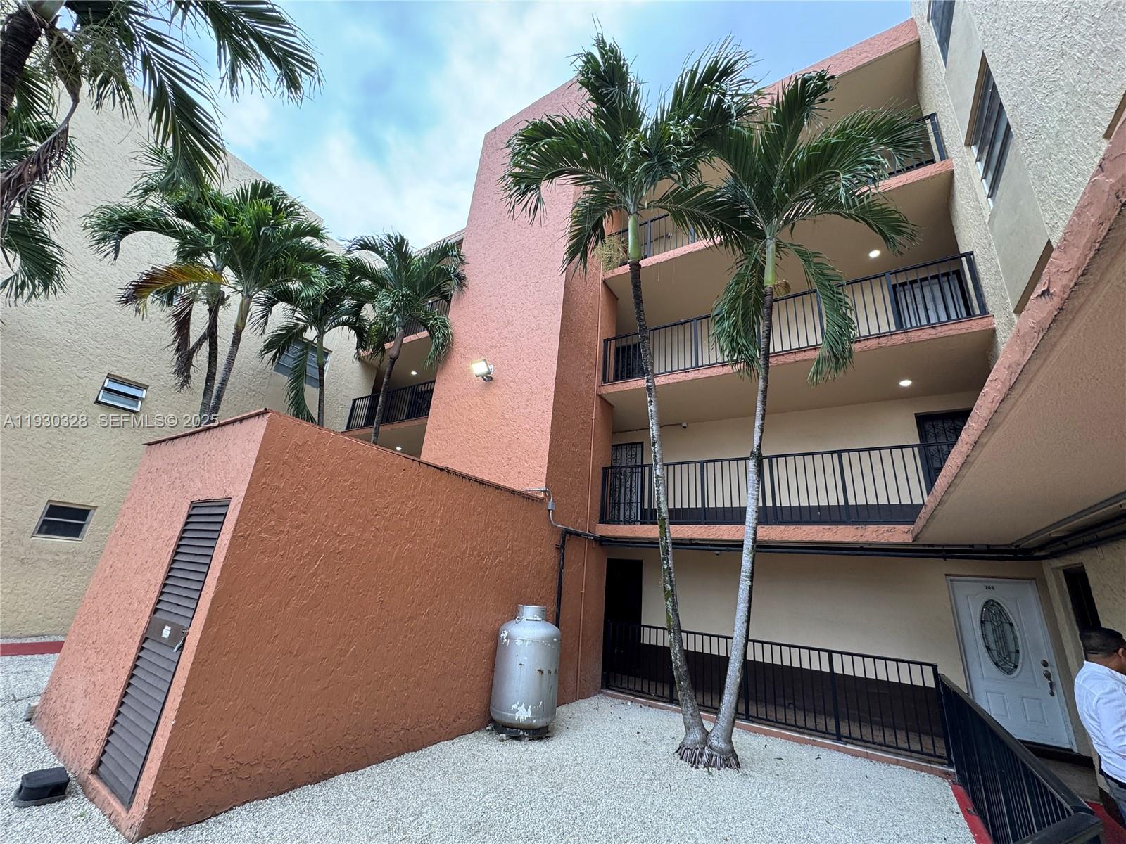 a view of balcony with potted plants and palm trees
