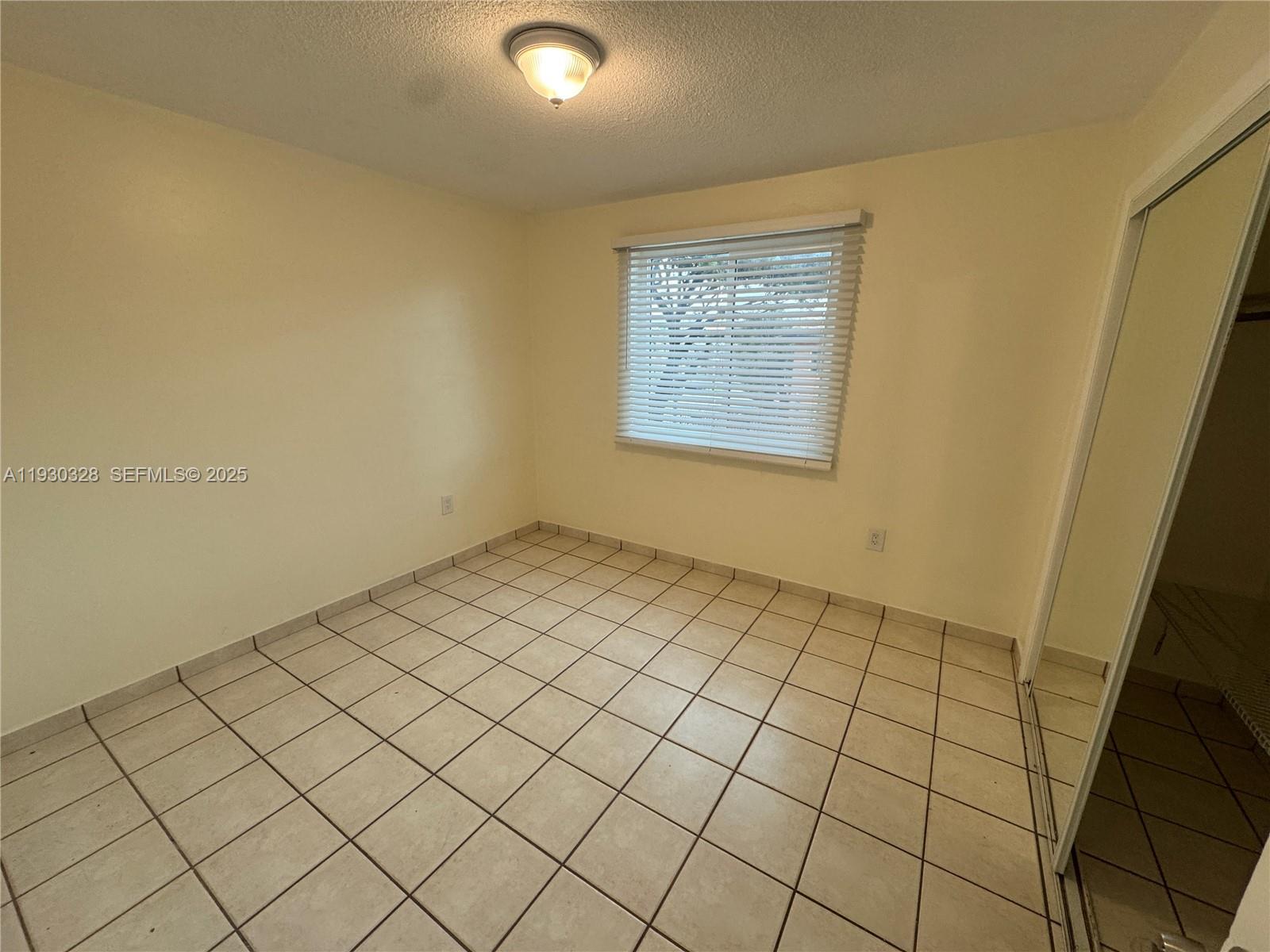 677 Southwest 9th Avenue, Unit 212 Miami, FL 33130 - Photo 13 of 19 a view of an empty room and window