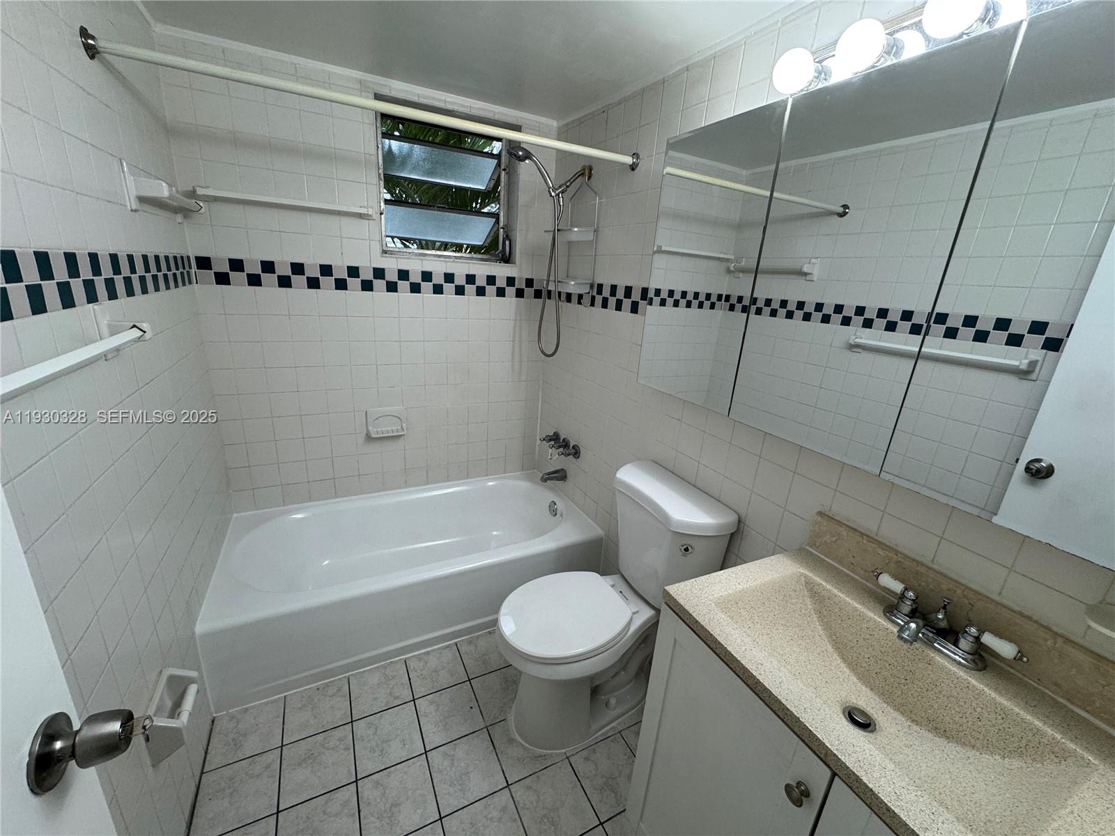 677 Southwest 9th Avenue, Unit 212 Miami, FL 33130 - Photo 14 of 19 a bathroom with a granite countertop sink a toilet and shower