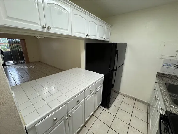 a kitchen with a sink and a stove top oven