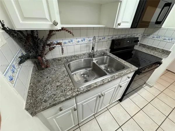 a kitchen with a stove and a refrigerator