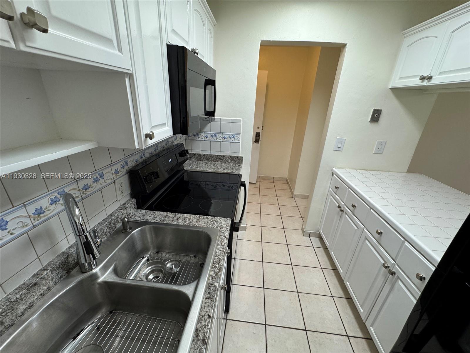 677 Southwest 9th Avenue, Unit 212 Miami, FL 33130 - Photo 6 of 19 a kitchen with a stove and a refrigerator