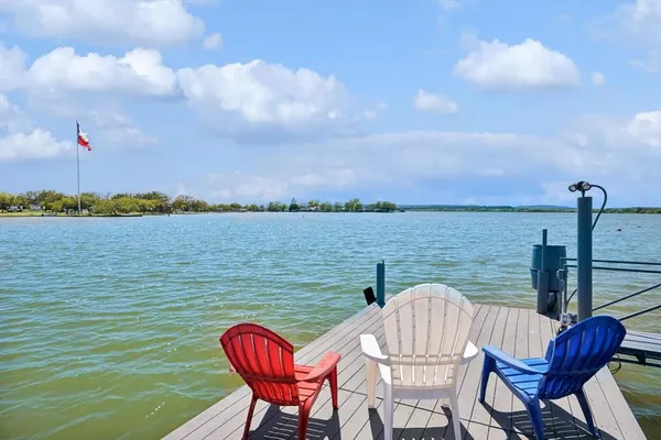 a view of a lake from a chair and tables