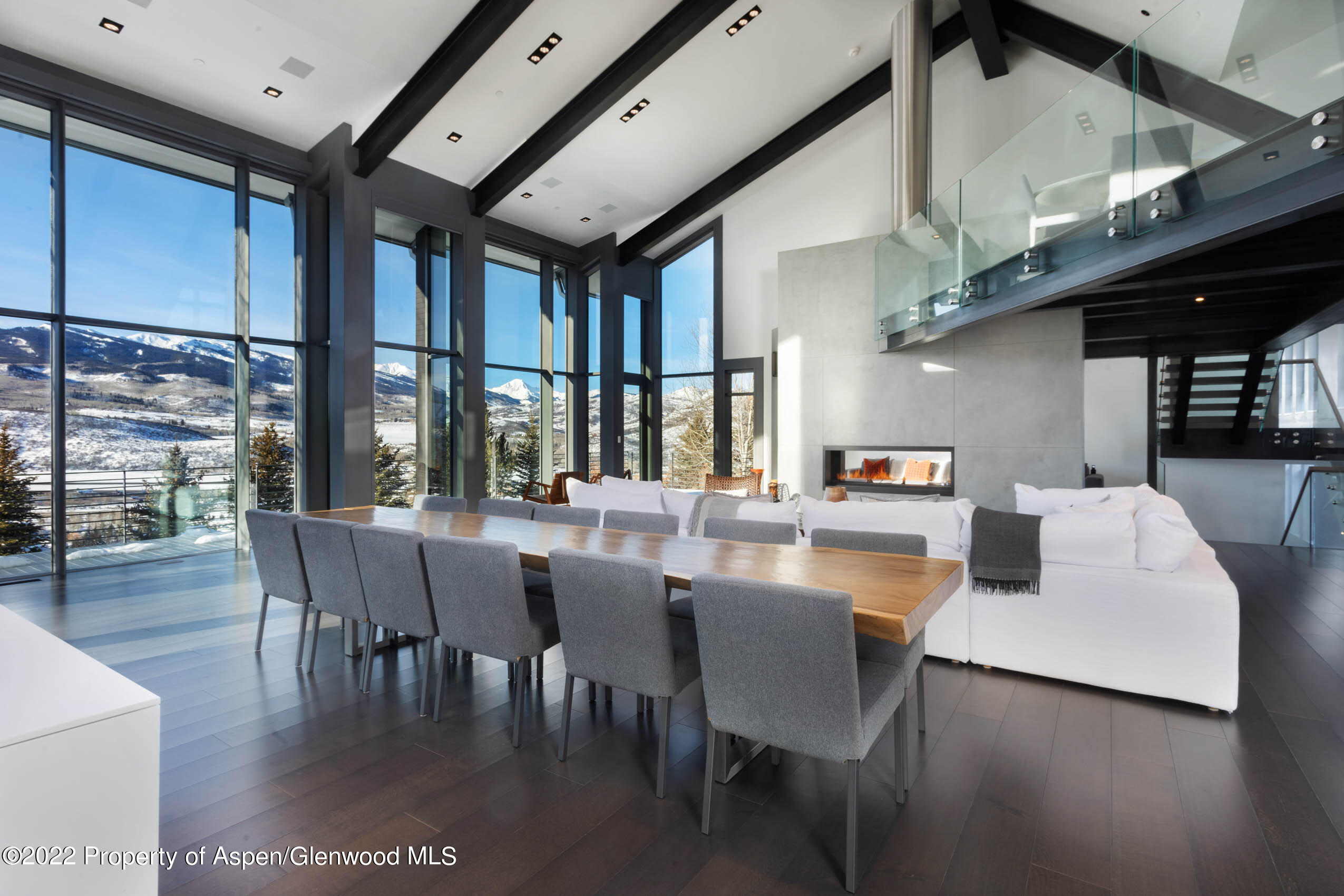 2780 McLain Flats Road Aspen, CO 81612 - Photo 14 of 46 a dining hall with stainless steel appliances granite countertop a stove a refrigerator a dining table and chairs with wooden floor
