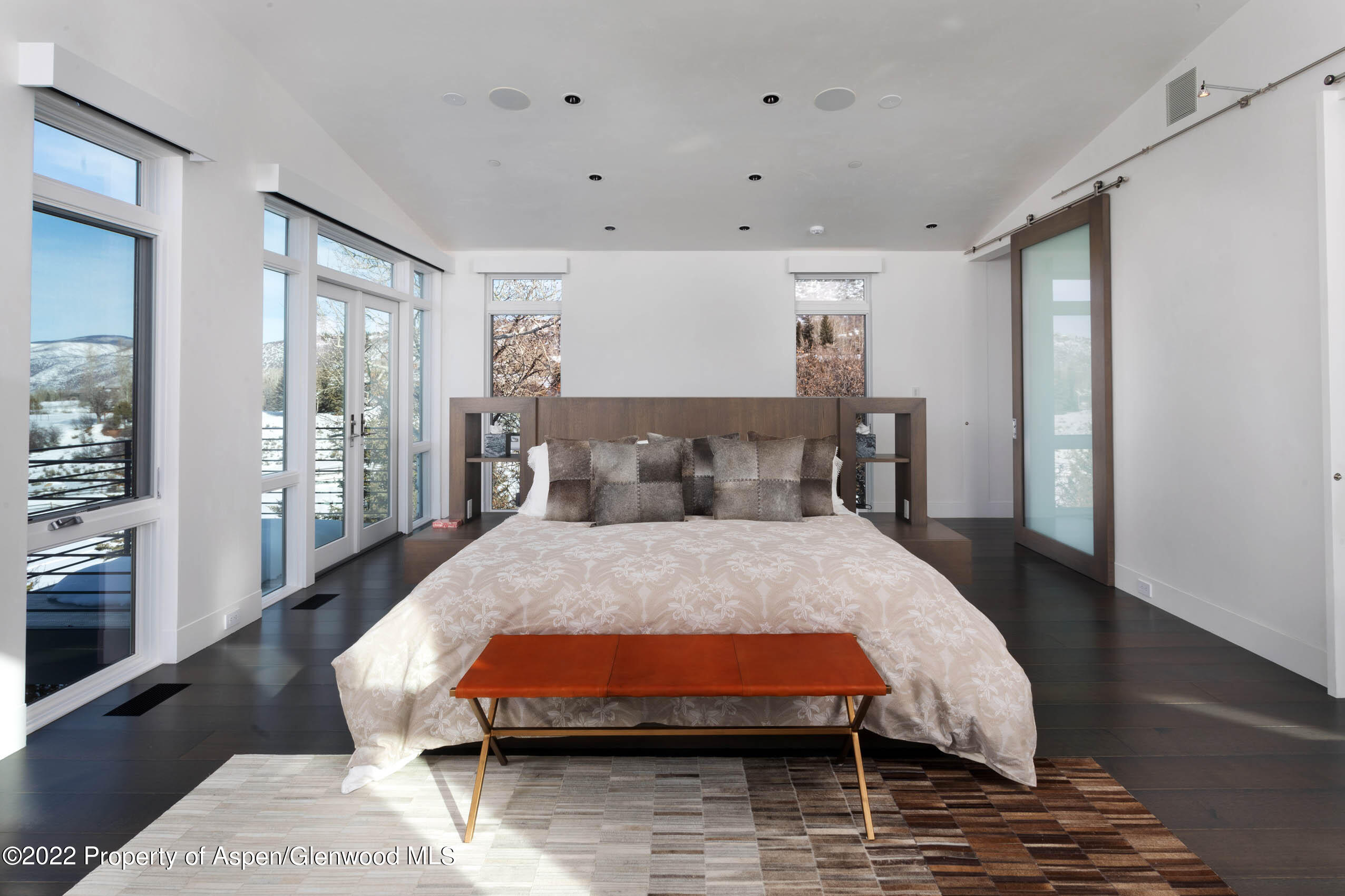 2780 McLain Flats Road Aspen, CO 81612 - Photo 32 of 46 a bed sitting in a spacious bedroom next to a window