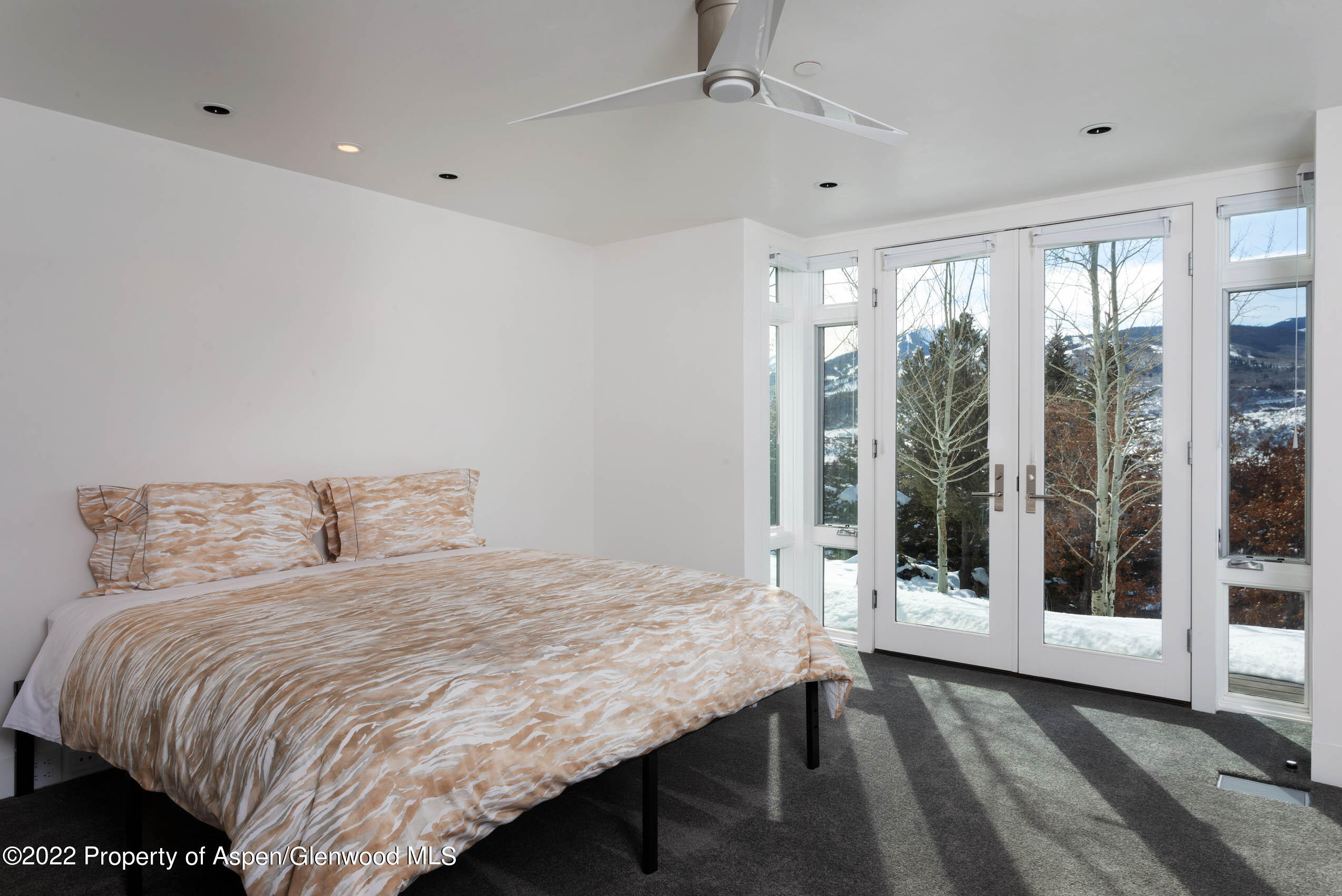 2780 McLain Flats Road Aspen, CO 81612 - Photo 38 of 46 a bedroom with a bed and a large window