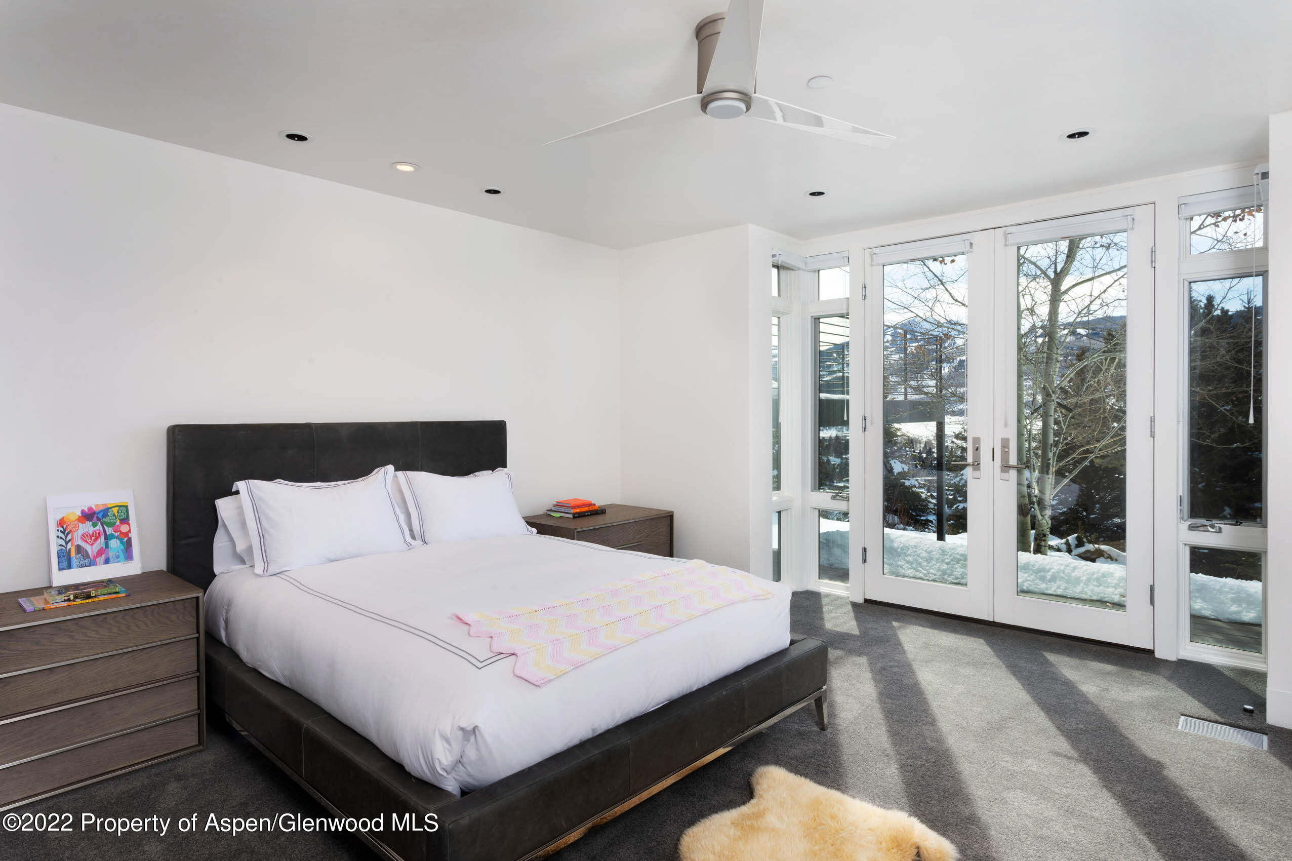 2780 McLain Flats Road Aspen, CO 81612 - Photo 39 of 46 a bedroom with a large bed and a large window