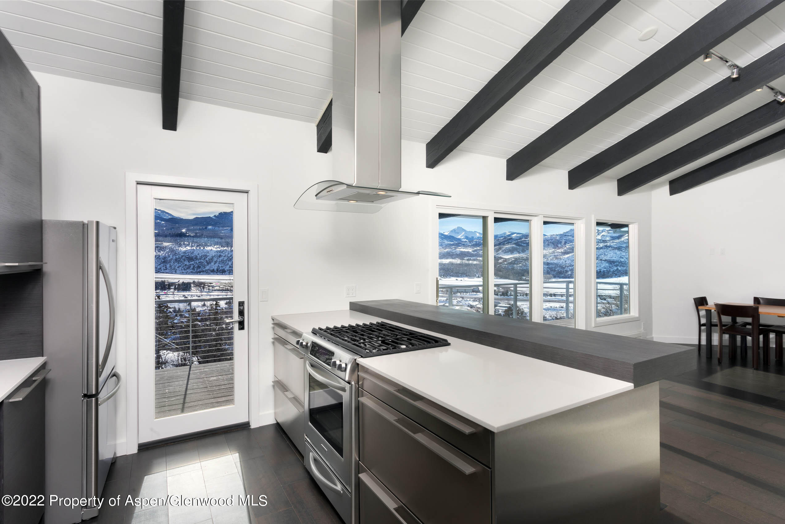 2780 McLain Flats Road Aspen, CO 81612 - Photo 44 of 46 a kitchen that has a stove and a table chair