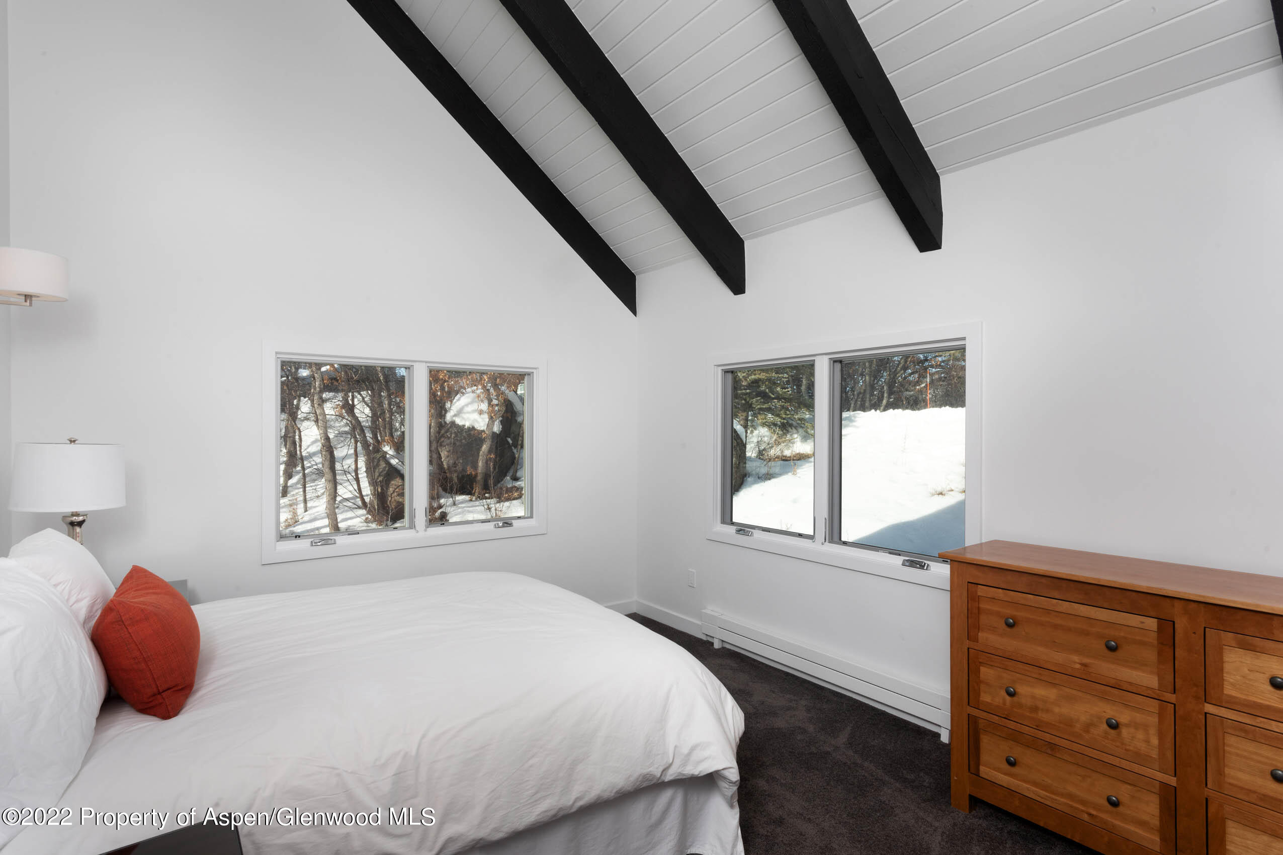 2780 McLain Flats Road Aspen, CO 81612 - Photo 45 of 46 a bedroom with a large bed and a window