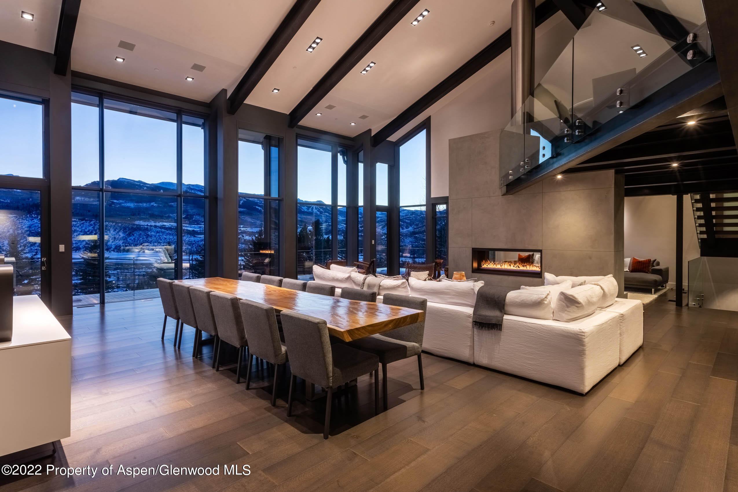 2780 McLain Flats Road Aspen, CO 81612 - Photo 5 of 46 a living room with couches a table and chairs with wooden floor