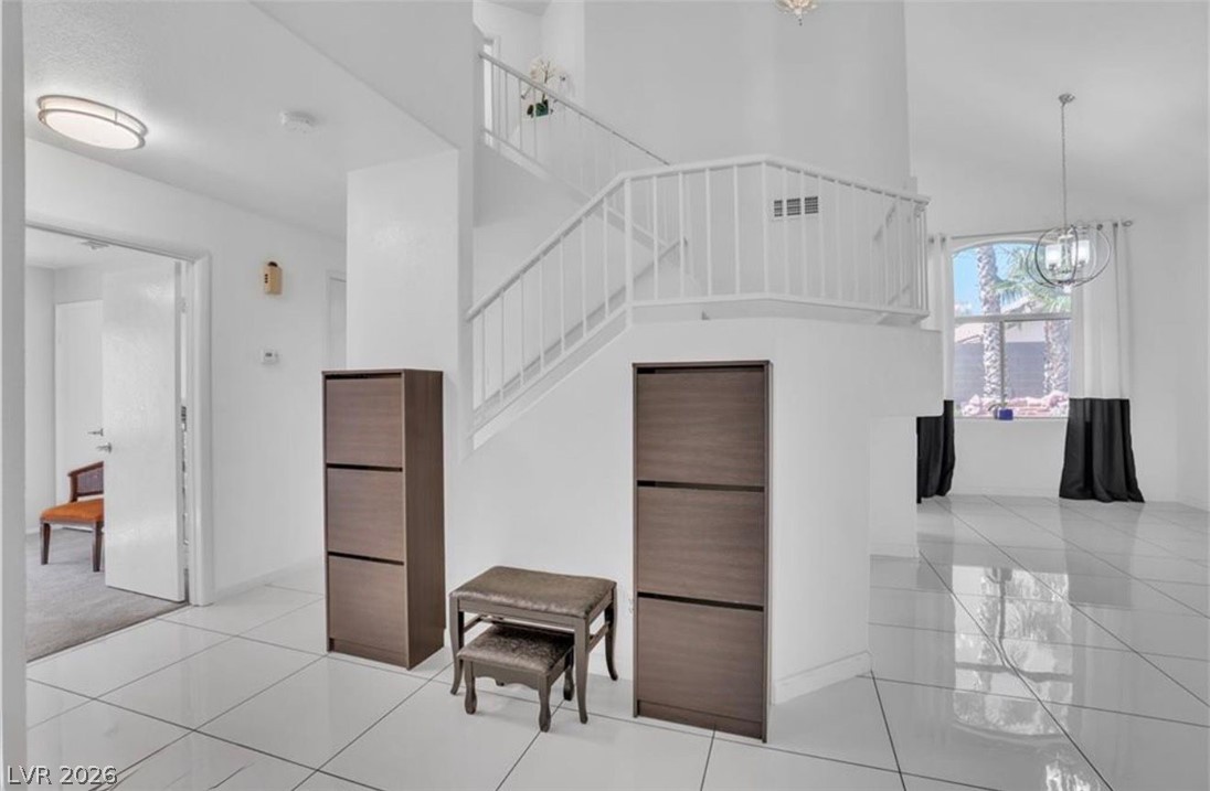 6429 Winding Ridge Las Vegas, NV 89156 - Photo 18 of 22 A grand entrance with a gleaming tile floor and a prominent staircase defines this inviting foyer.