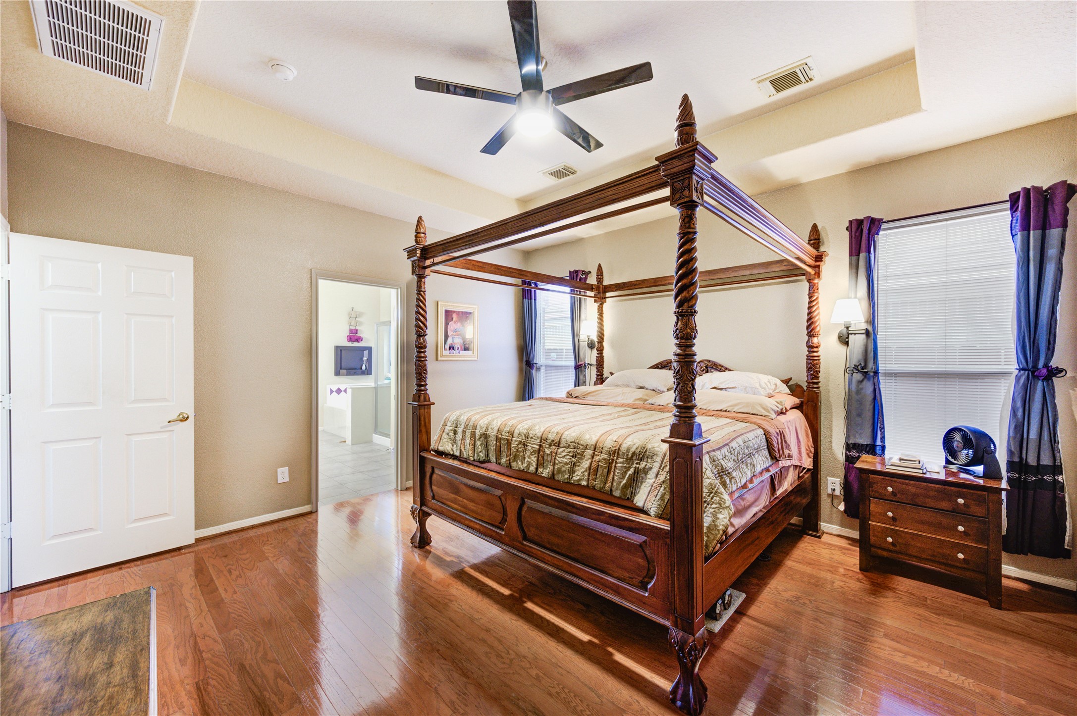 16730 Spring Barker Drive Cypress, TX 77429 - Photo 34 of 50 a bedroom with a bed a large window and a chandelier
