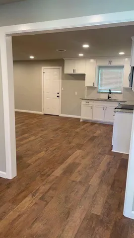 a view of a kitchen with a sink and cabinets