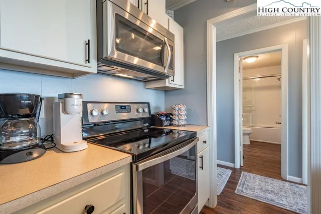 a kitchen with stainless steel appliances granite countertop a stove and a microwave