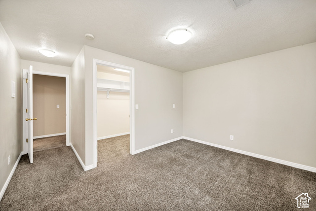 1143 East Mountain Road Logan, UT 84321 - Photo 32 of 64 Carpeted room with neutral wall tones and a built-in closet featuring shelving and a hanging rod