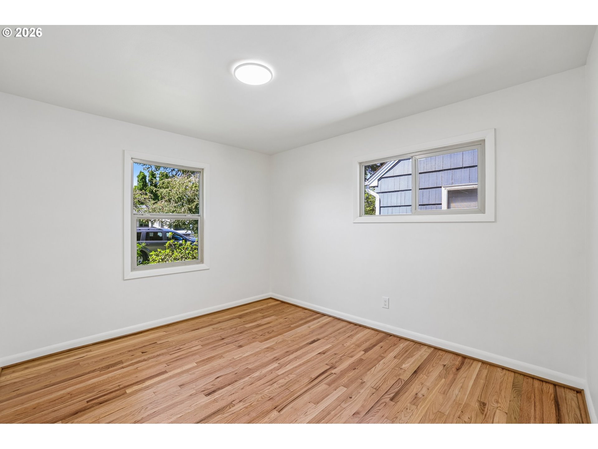 536 28th Avenue Longview, WA 98632 - Photo 12 of 27 a view of an empty room with wooden floor and a window