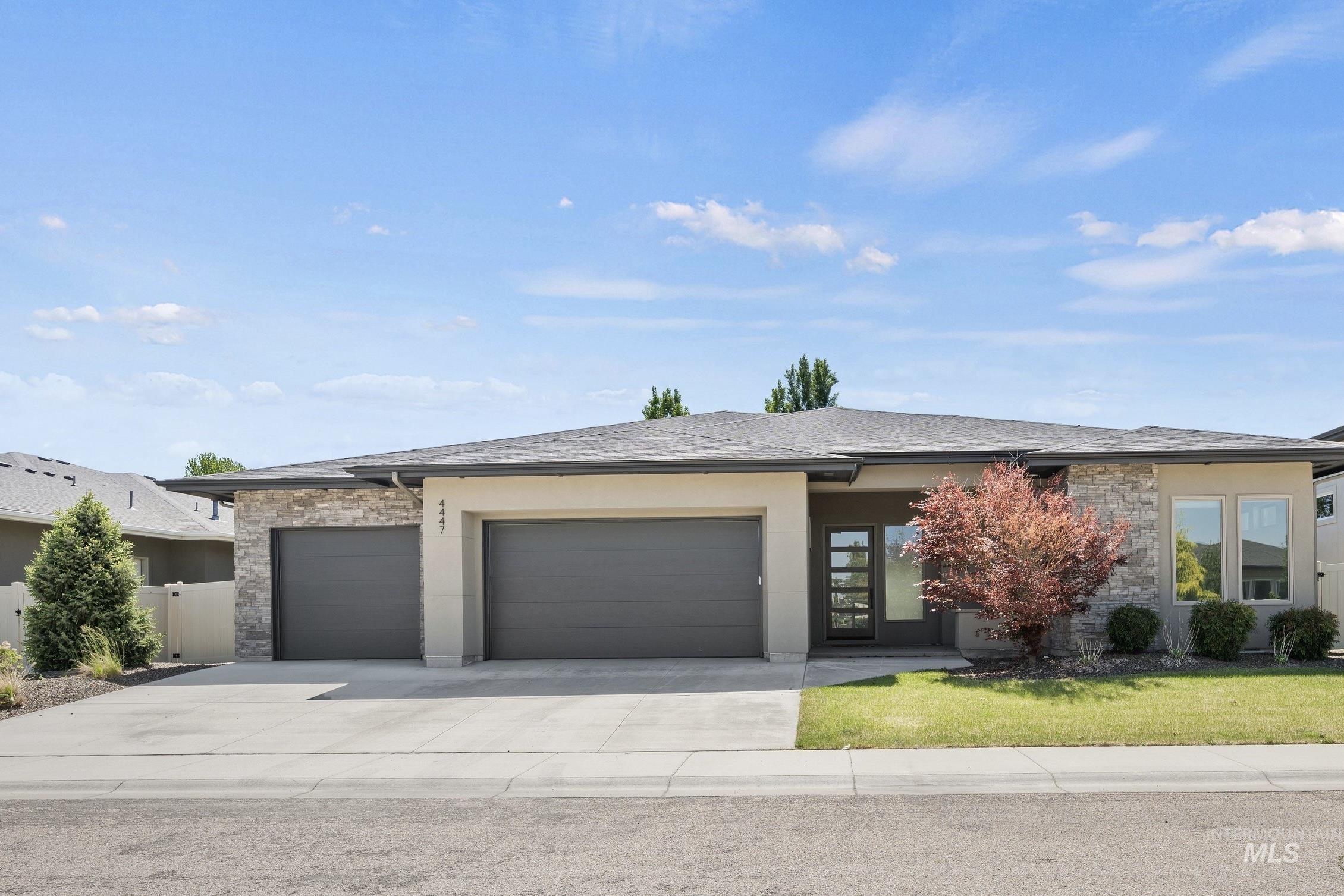 4447 East Copper Point Drive Meridian, ID 83642 - Photo 1 of 41 Contemporary single-story residence featuring a stone and stucco exterior