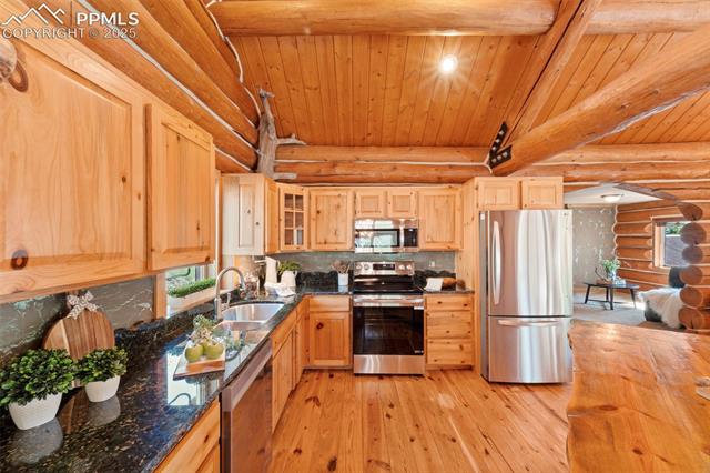 Kitchen featuring new stainless steel appliances, granite countertops with chiseled backsplash
