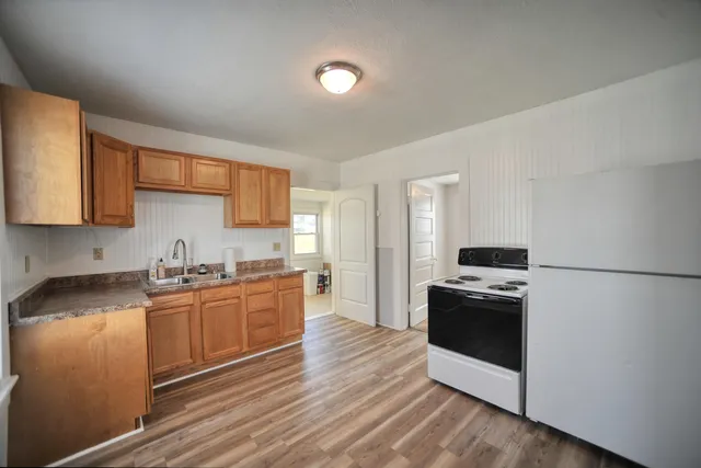 a kitchen with granite countertop a stove top oven and sink