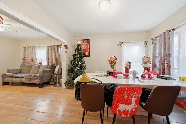 a view of a dining room with furniture and a chandelier