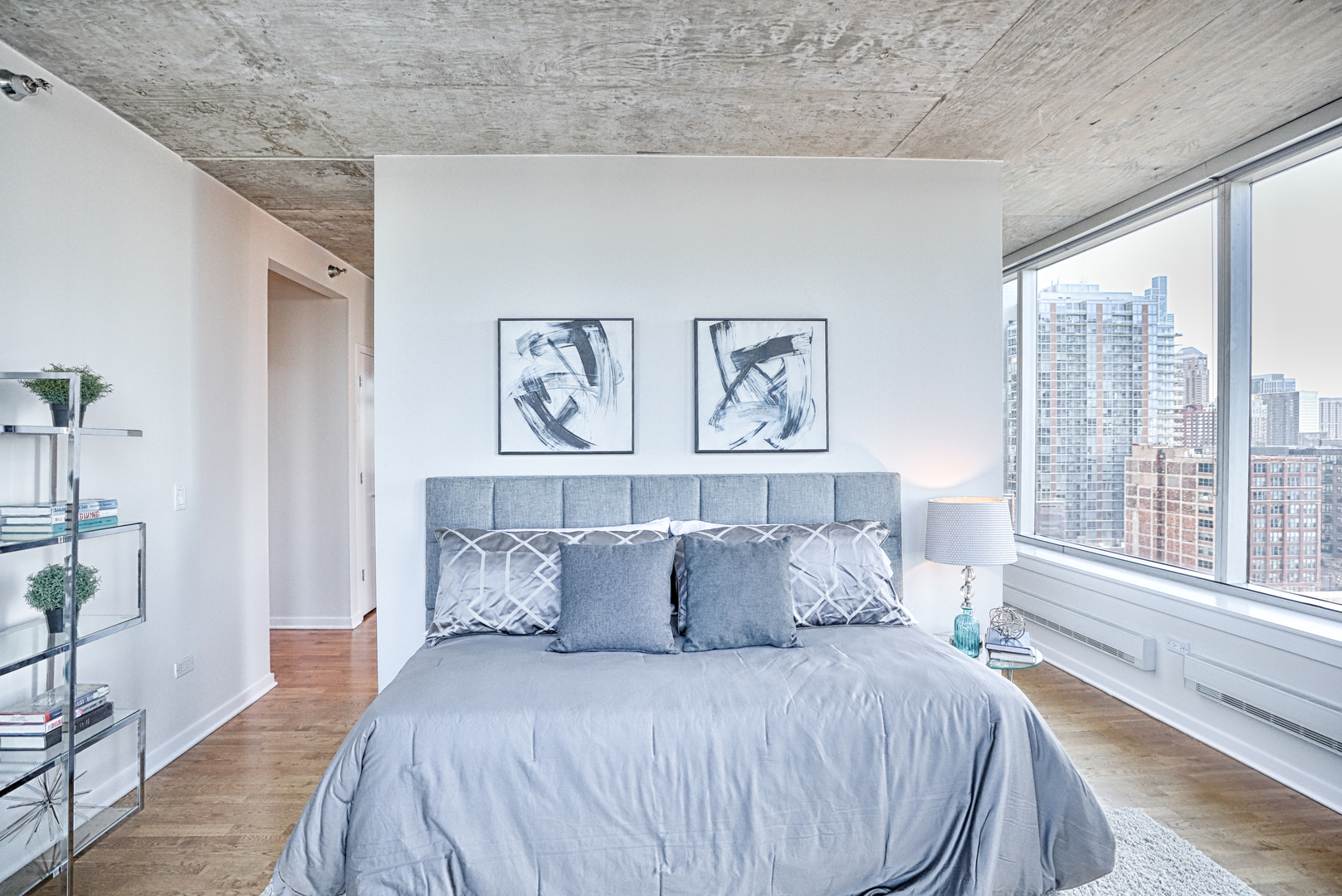 611 South Wells Street, Unit 1507 Chicago, IL 60607 - Photo 11 of 20 a large bed sitting in a bedroom next to a window