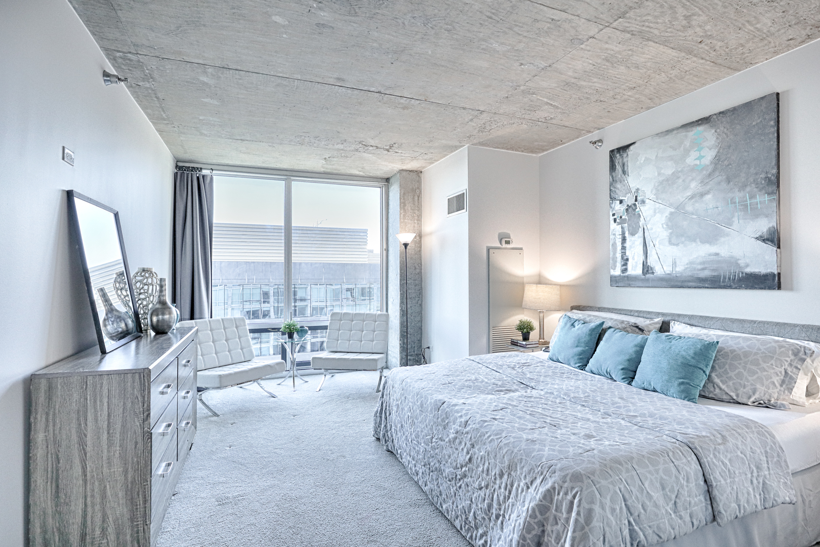 611 South Wells Street, Unit 1507 Chicago, IL 60607 - Photo 17 of 20 a bedroom with a large bed and a large window