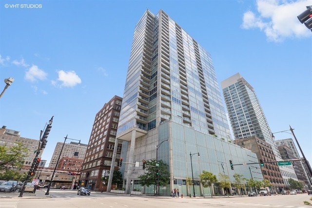 611 South Wells Street, Unit 1507 Chicago, IL 60607 - Photo 2 of 20 a view of a tall building next to a road