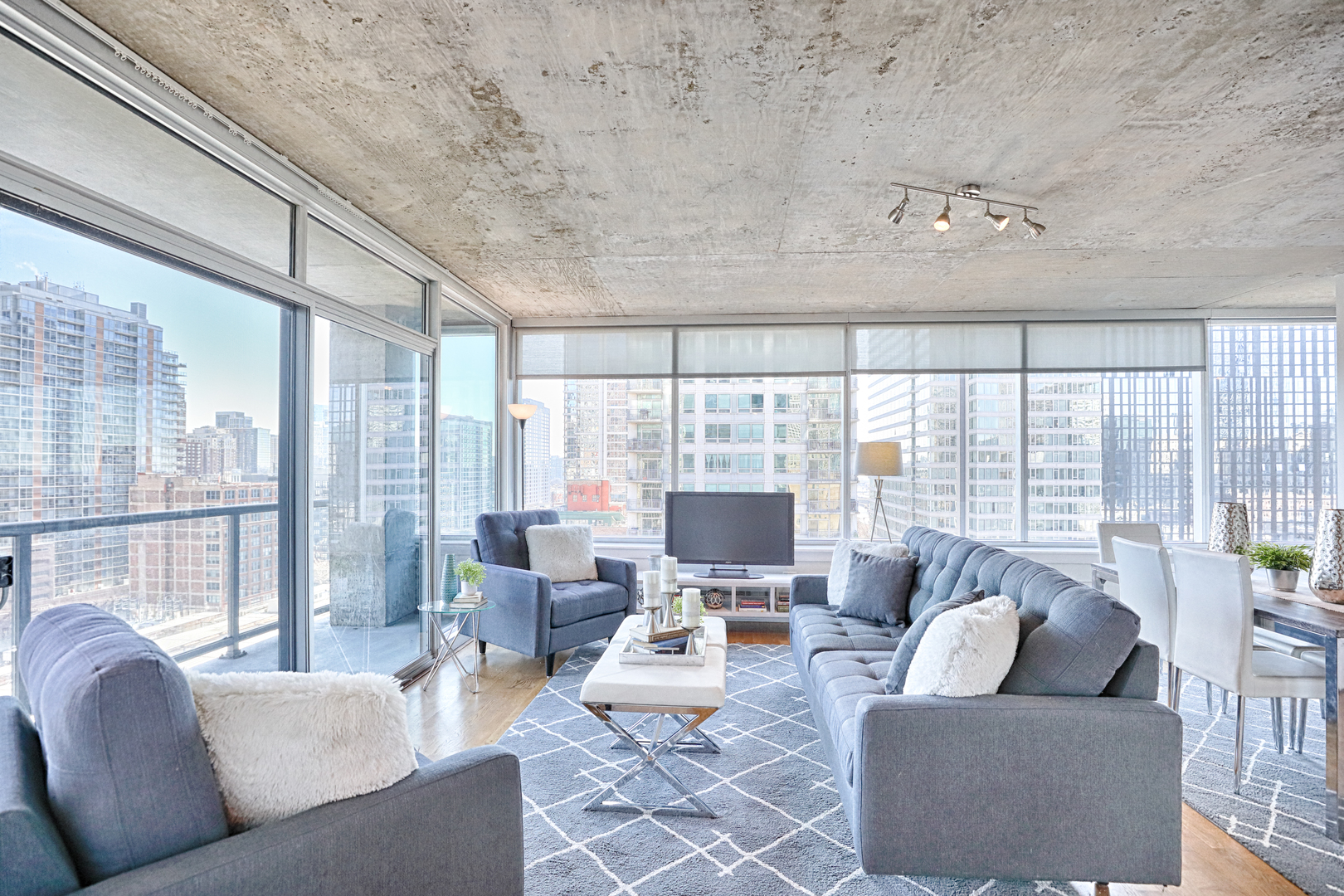 611 South Wells Street, Unit 1507 Chicago, IL 60607 - Photo 3 of 20 a living room with furniture and large windows