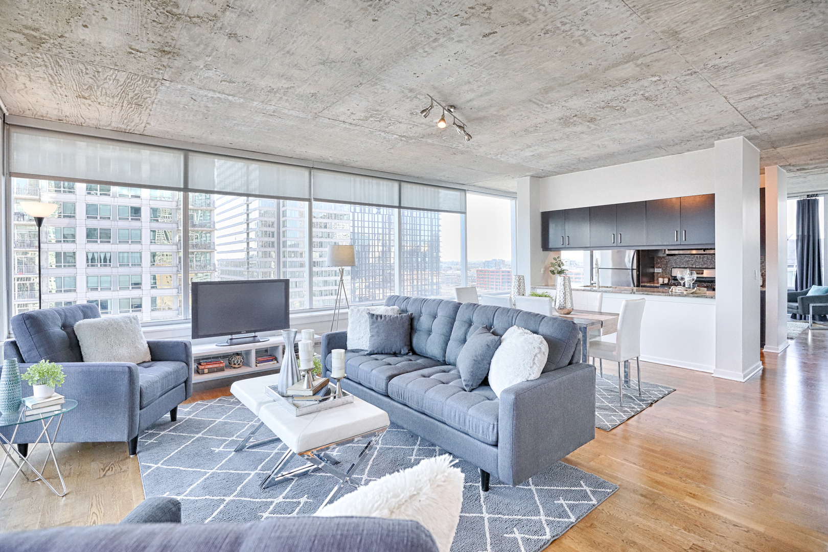 611 South Wells Street, Unit 1507 Chicago, IL 60607 - Photo 4 of 20 a living room with furniture and a flat screen tv